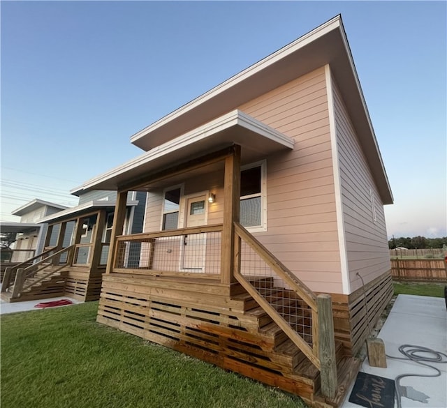 back of house with a lawn