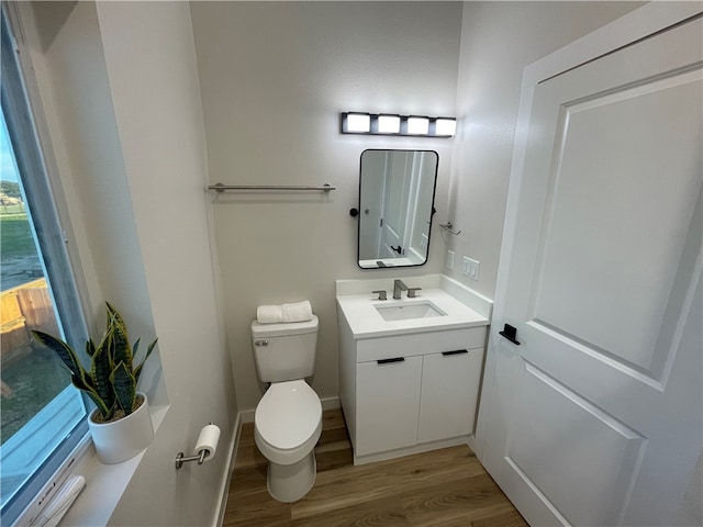 bathroom featuring hardwood / wood-style floors, vanity, and toilet