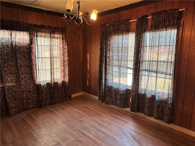 4721 Molina Dr, Corpus Christi, TX 78416 - unfurnished room with wood finished floors, a chandelier, and wood walls