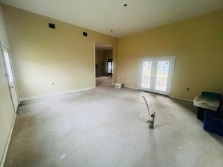 unfurnished living room featuring french doors