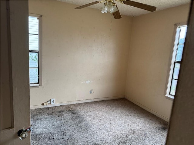 unfurnished room featuring ceiling fan, carpet, and a textured ceiling