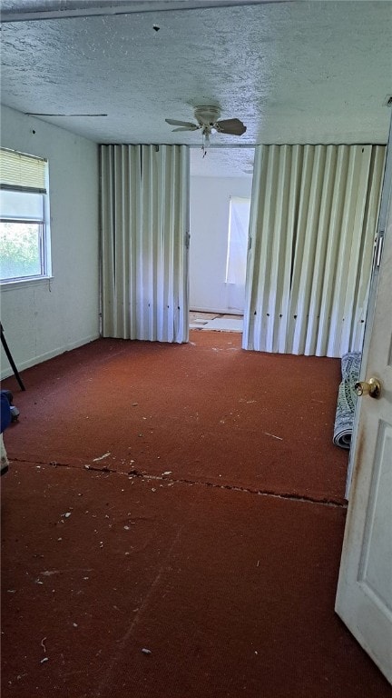 unfurnished room with a textured ceiling
