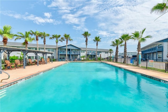 1129 S Eleventh St Unit 12, Port Aransas, TX 78373 - community pool featuring a pergola, a residential view, and a patio area
