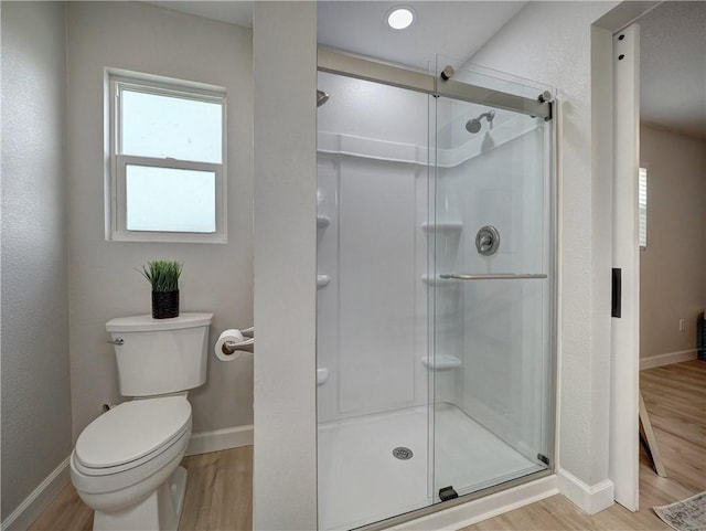 222 N 9th St, Aransas Pass, TX 78336 - full bath with wood finished floors, a shower stall, and baseboards