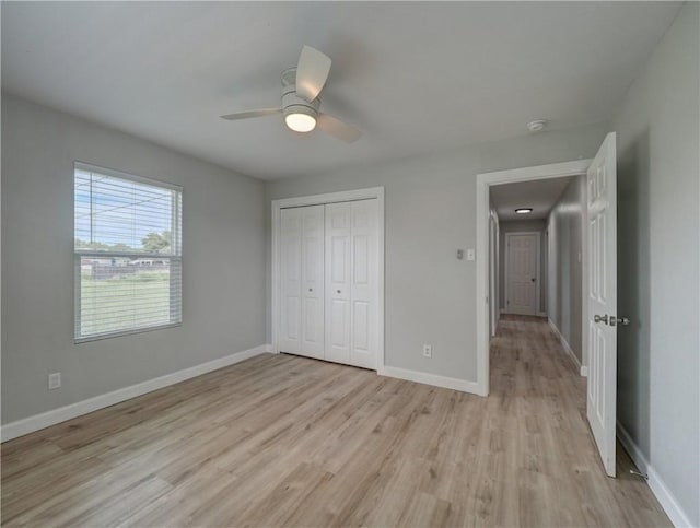 222 N 9th St, Aransas Pass, TX 78336 - unfurnished bedroom with light wood finished floors, a closet, baseboards, and ceiling fan