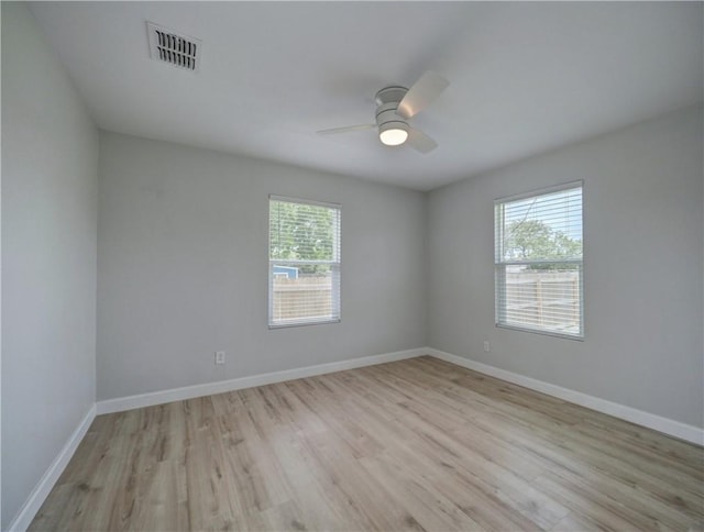222 N 9th St, Aransas Pass, TX 78336 - spare room featuring light wood-style flooring, a ceiling fan, and baseboards