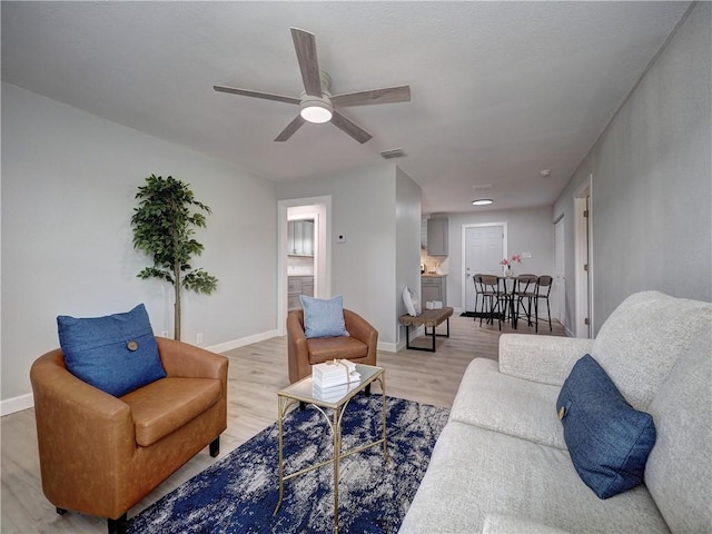 222 N 9th St, Aransas Pass, TX 78336 - living room featuring light wood-type flooring, a ceiling fan, and baseboards