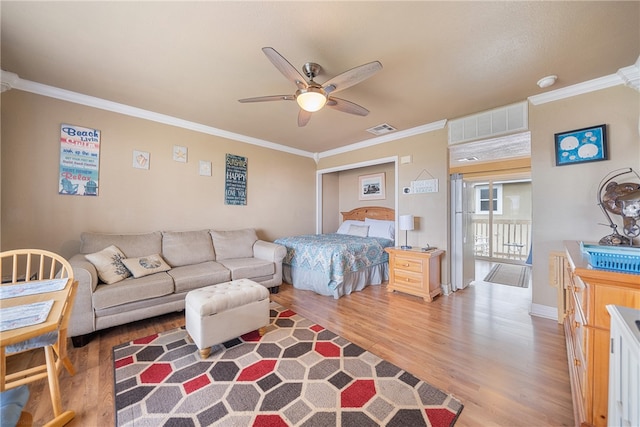 bedroom featuring ceiling fan, wood-type flooring, and ornamental molding