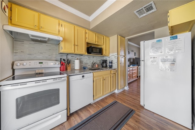 kitchen featuring white appliances, sink, crown molding, decorative backsplash, and light hardwood / wood-style floors