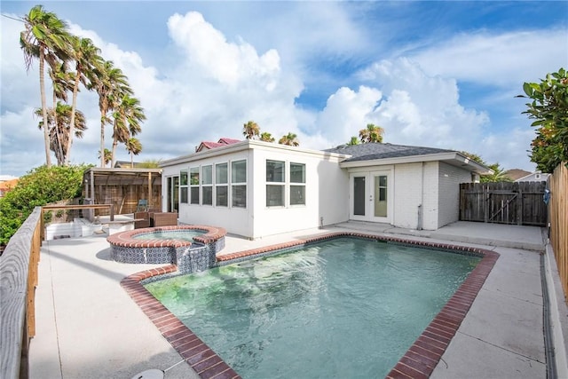 13765 Eaglesnest Bay Dr, Corpus Christi, TX 78418 - rear view of house featuring french doors, a patio, a fenced backyard, a pool with connected hot tub, and brick siding
