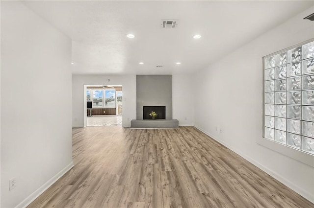 13765 Eaglesnest Bay Dr, Corpus Christi, TX 78418 - unfurnished living room featuring light wood-type flooring, a large fireplace, and recessed lighting