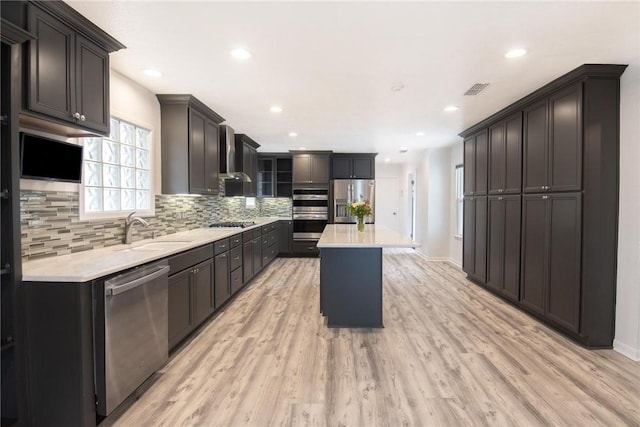 13765 Eaglesnest Bay Dr, Corpus Christi, TX 78418 - kitchen featuring appliances with stainless steel finishes, light countertops, backsplash, recessed lighting, and light wood-type flooring
