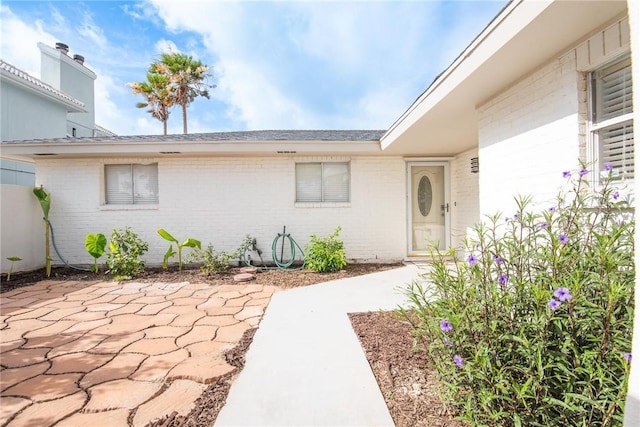 13765 Eaglesnest Bay Dr, Corpus Christi, TX 78418 - doorway to property with brick siding and a patio area