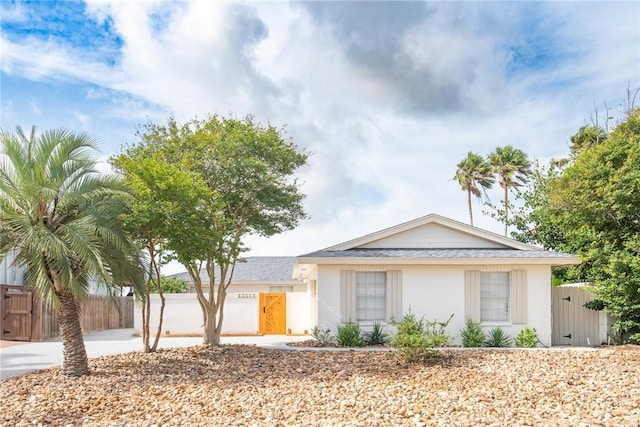 13765 Eaglesnest Bay Dr, Corpus Christi, TX 78418 - view of front of property featuring a gate, driveway, and roof with shingles