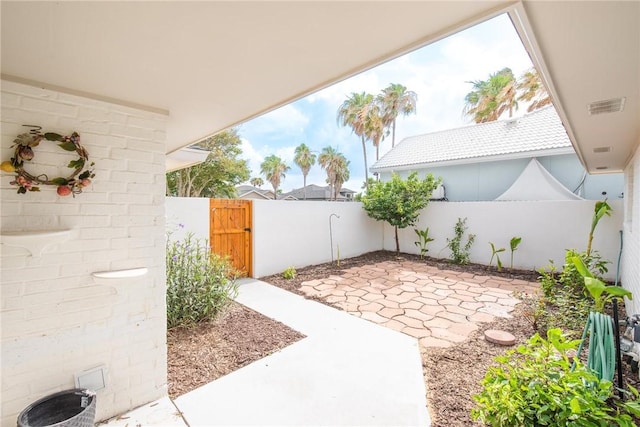 13765 Eaglesnest Bay Dr, Corpus Christi, TX 78418 - fenced backyard featuring a gate and a patio