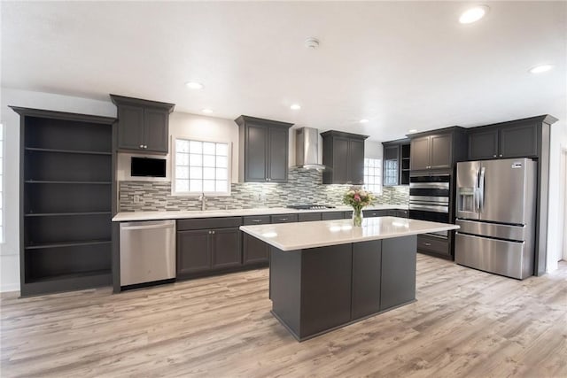 13765 Eaglesnest Bay Dr, Corpus Christi, TX 78418 - kitchen featuring stainless steel appliances, open shelves, wall chimney range hood, light countertops, and light wood-style flooring
