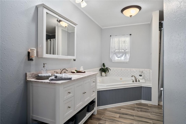 bathroom with vanity, a tub to relax in, and ornamental molding