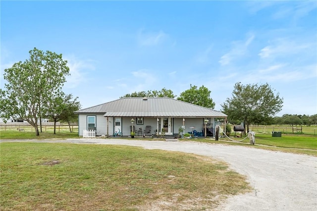 single story home featuring a porch and a front yard