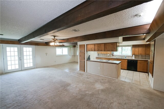 kitchen featuring light carpet, ceiling fan, dishwasher, and beamed ceiling