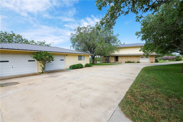 ranch-style home with a front lawn and a garage