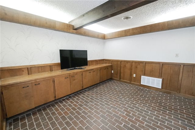 basement featuring a textured ceiling