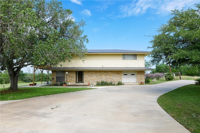 view of front of property with a garage and a front lawn