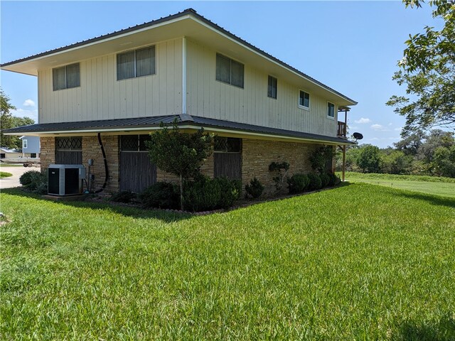 view of property exterior featuring a lawn and central air condition unit