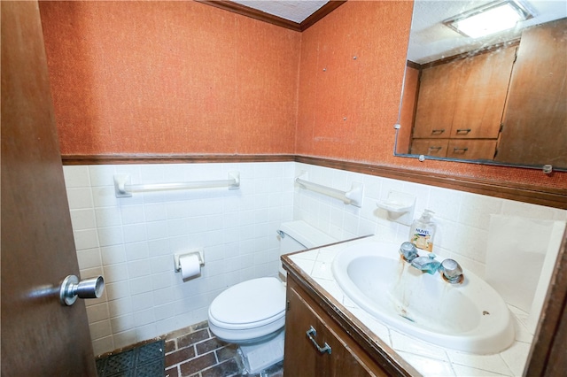 bathroom featuring toilet, tile walls, tile patterned floors, and vanity