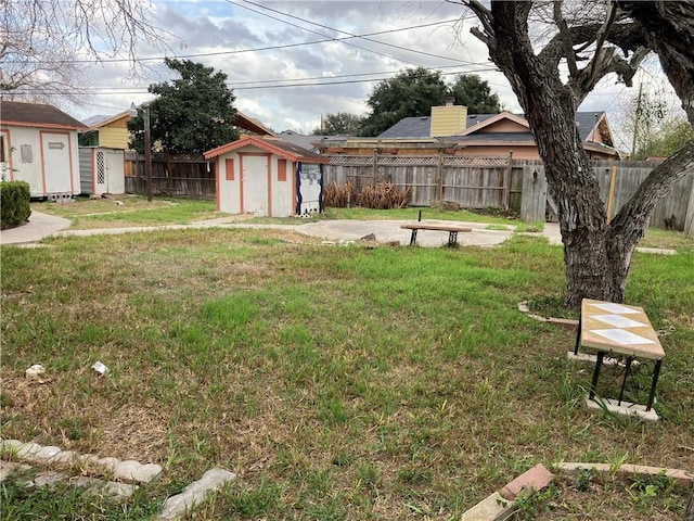 view of yard with a fenced backyard, an outdoor structure, a patio, and a shed