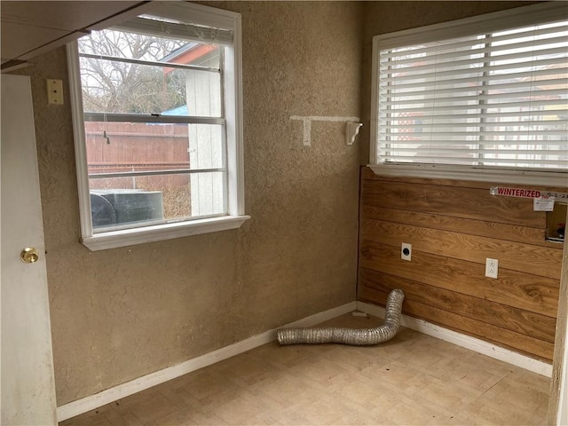 unfurnished room featuring baseboards and tile patterned floors