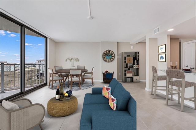 living room featuring plenty of natural light and floor to ceiling windows