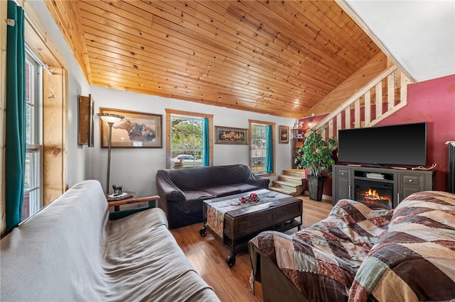 living room featuring wooden ceiling, light hardwood / wood-style floors, and vaulted ceiling