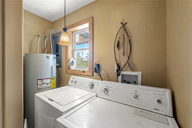 laundry room featuring electric water heater and separate washer and dryer