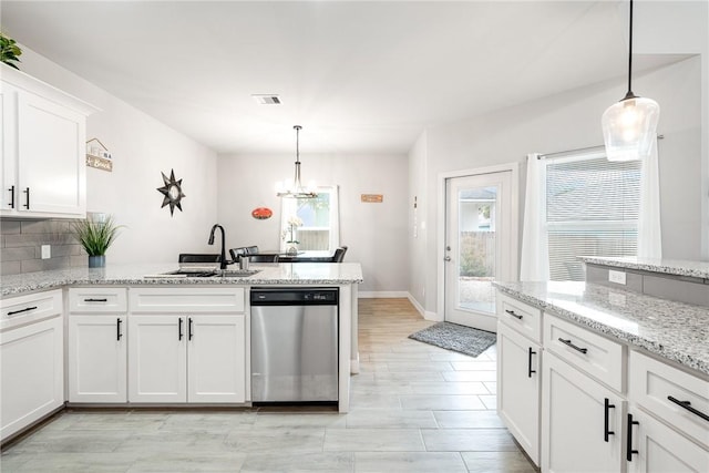 15417 Palmira Ave Unit B, Corpus Christi, TX 78418 - kitchen featuring stainless steel dishwasher, a sink, a peninsula, a chandelier, and white cabinetry