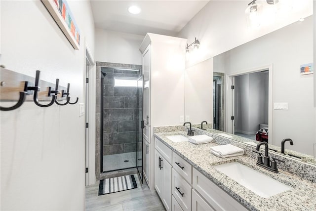 15417 Palmira Ave Unit B, Corpus Christi, TX 78418 - full bathroom featuring double vanity, a shower stall, and wood finished floors