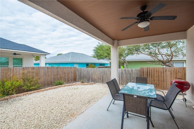 15417 Palmira Ave Unit B, Corpus Christi, TX 78418 - fenced backyard with a ceiling fan, outdoor dining area, and a patio
