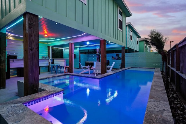 268 Flounder Dr, Port Aransas, TX 78373 - pool at dusk with a fenced backyard, a hot tub, and a patio area