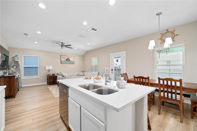 268 Flounder Dr, Port Aransas, TX 78373 - kitchen featuring stainless steel dishwasher, light wood-style flooring, light countertops, plenty of natural light, and recessed lighting