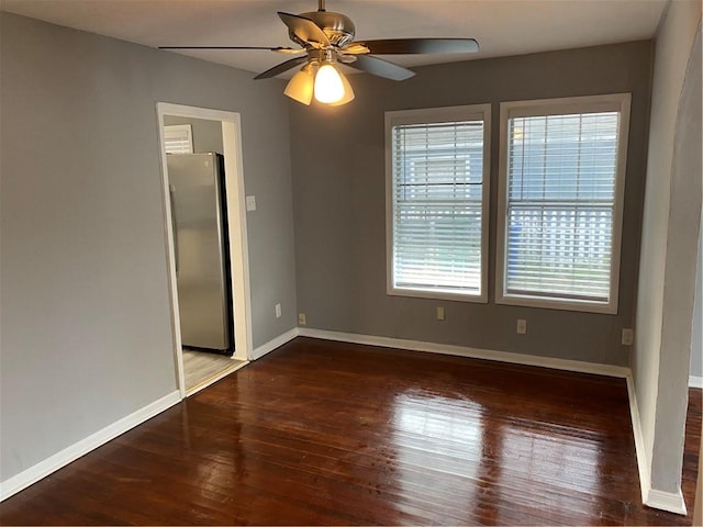 spare room with ceiling fan and dark hardwood / wood-style flooring