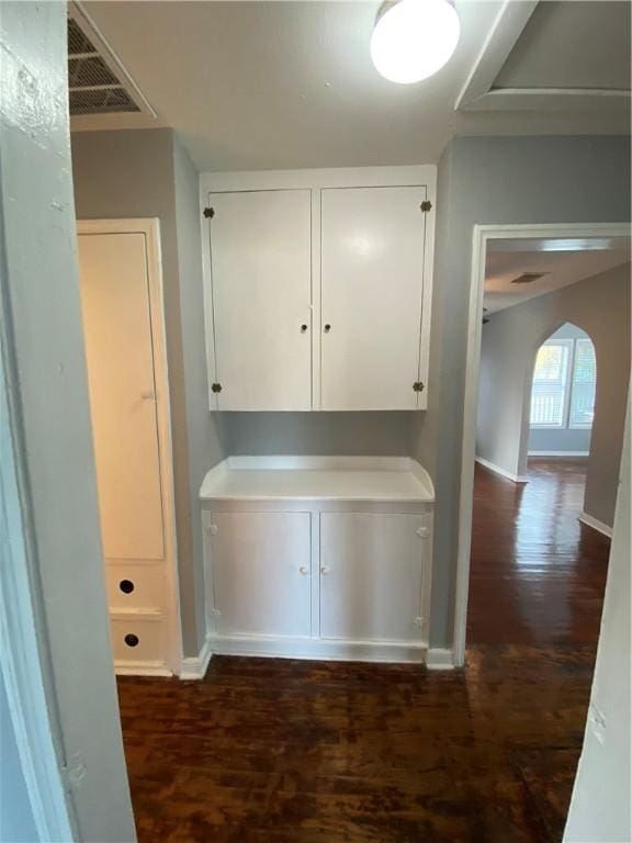 hallway with dark hardwood / wood-style flooring