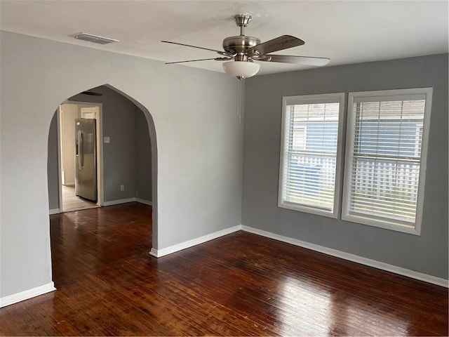 spare room featuring ceiling fan and dark hardwood / wood-style flooring