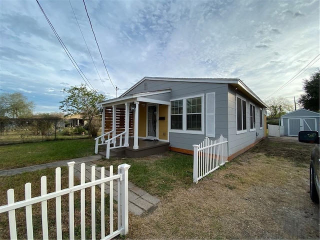 view of front facade featuring a storage unit and a front lawn