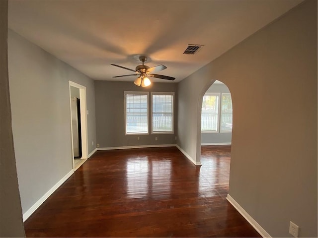 unfurnished room with dark hardwood / wood-style flooring and ceiling fan