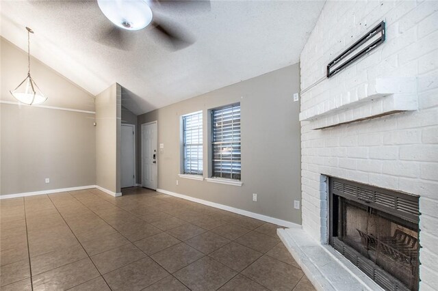 unfurnished living room with tile patterned flooring, lofted ceiling, a fireplace, a textured ceiling, and a ceiling fan