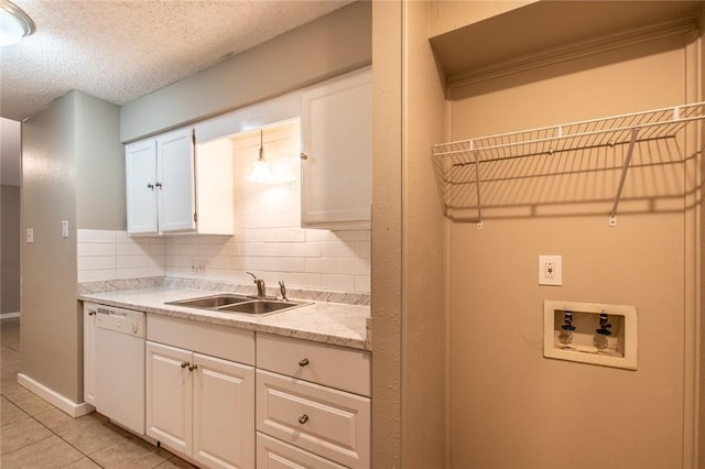 kitchen with light countertops, white dishwasher, backsplash, and a sink