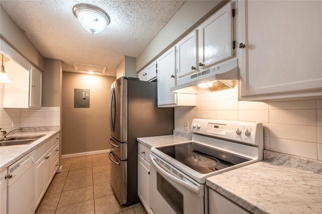 kitchen with white cabinetry, white appliances, under cabinet range hood, and a sink