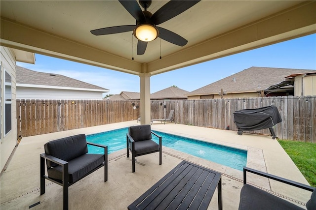 view of swimming pool featuring a patio area, ceiling fan, and area for grilling