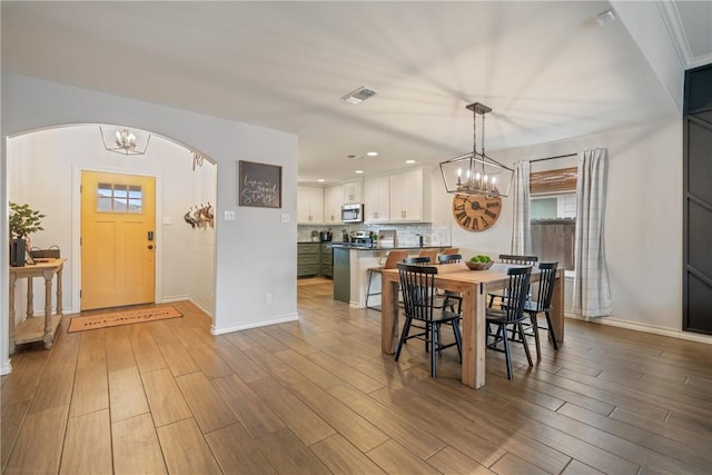 dining room featuring a chandelier, wood-type flooring, and a wealth of natural light