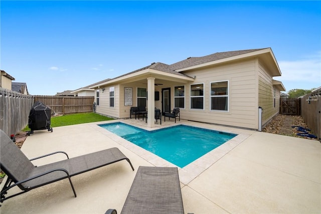 view of swimming pool with grilling area, ceiling fan, and a patio