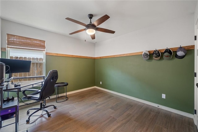 home office with hardwood / wood-style flooring and ceiling fan